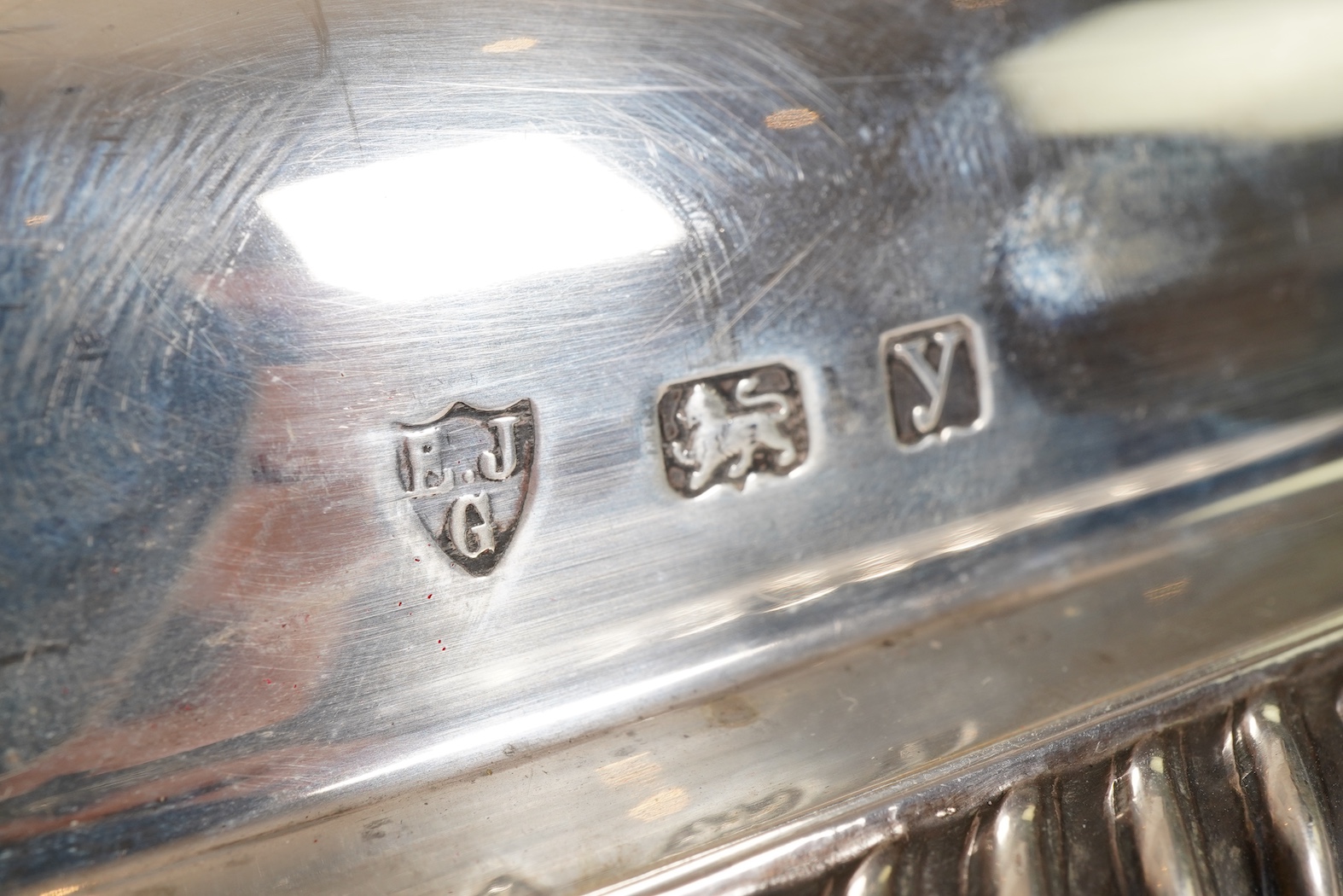 A matched pair of George V silver rectangular entrée dishes and covers, both with gadrooned borders and similar unmarked handles, Ellis & Co, Birmingham, 1923 and Ellis & Co, Birmingham, 1932, base 27.8cm, 108.3oz, exclu